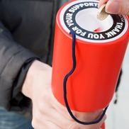 Hand puts pound into collection tin