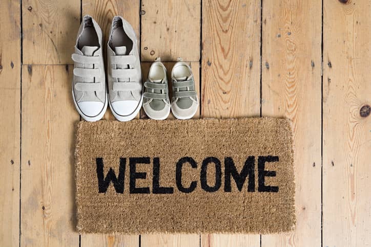 Welcome doormat with adult and child sized shoes