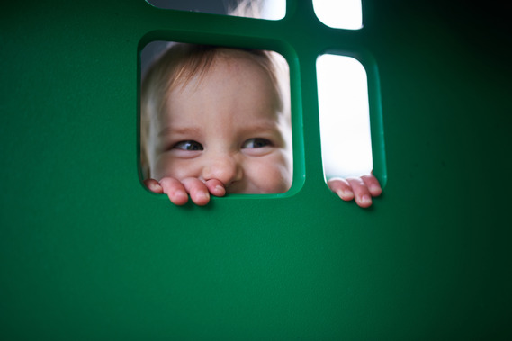 Child looking through a window