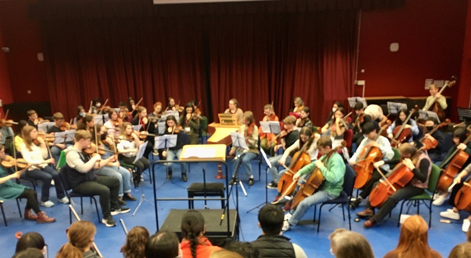 children performing violin and cello music in Lyng Hall school