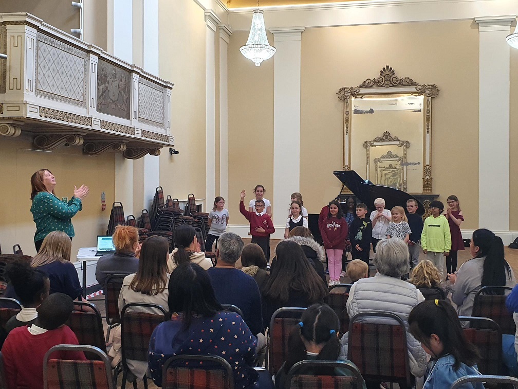 junior voices choir singing for watching parents at Drapers Hall