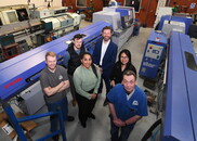 advisors and business owners next to machinery 