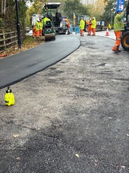 Image of Clifford Bridge Road surfacing with workers in the background