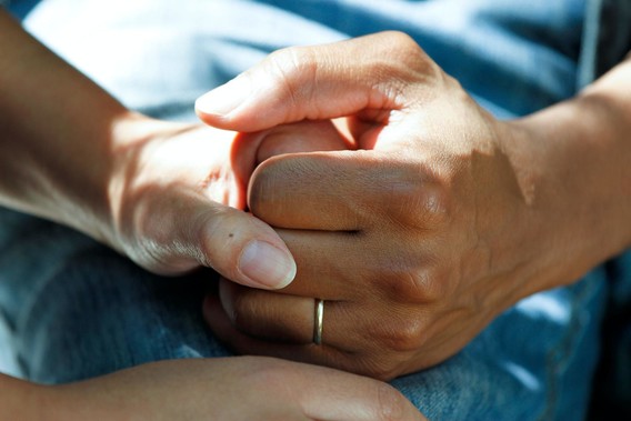 Close up of two people holding hands