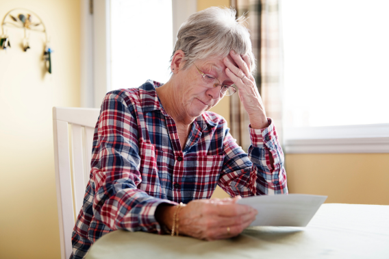 Concerned woman reading letter