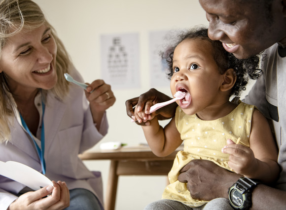 Child learning to brush teeth