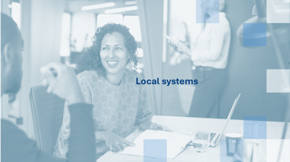 A person sitting at a table with a computer