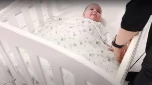 baby sleeping safely in cot