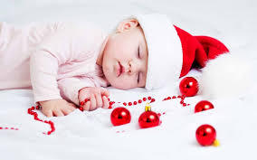 baby sleeping with christmas baubles