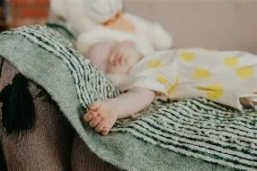 baby asleep on sofa
