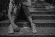 Teenage girl writing HELP on steps