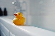 rubber duck on side of bath