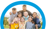 a group of children and young people smiling for camera