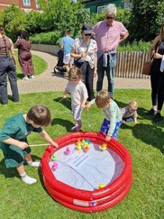 children playing in paddling pool with adult supervision