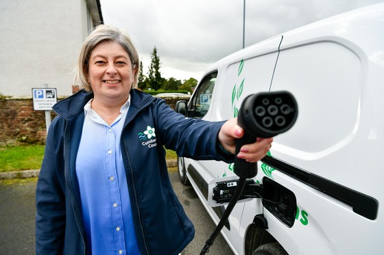 Cllr Denise Rollo charging one of Cumberland Councils electric vehicles