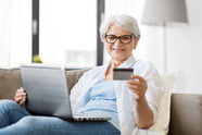 Older lady on computer with credit card