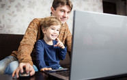 parent and child with laptop