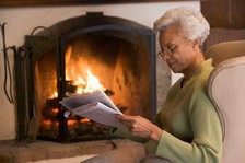 cosy stay warm older woman winter fireplace