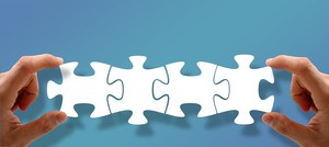 jigsaw pieces help together by hands