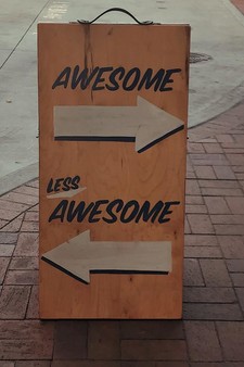 sign saying 'awesome' and 'less awesome'
