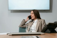Woman in blazer talking on the phone