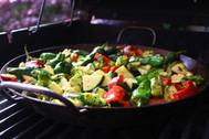 Various vegetables being cooked in a wok frying pan
