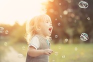Child chasing bubbles