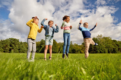 kids in nature summer activity outside school holiday children play field grass 