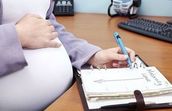 Pregnant woman at desk