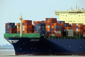 A ship loaded with containers seen from the port side