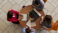 workers sitting round a table viewed from above