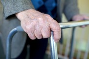 elderly hands on a walking frame