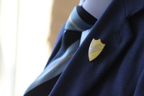 school tie and prefect badge