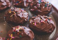 Chocolate cupcakes covered in chocolate buttercream and sprinkles