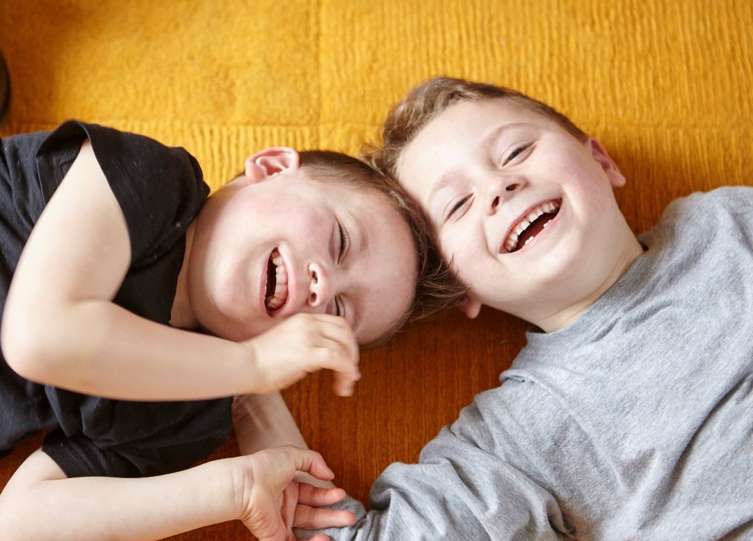 brothers laughing on the floor