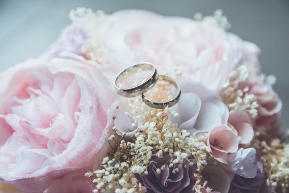 bouquet of flowers with two rings on top 
