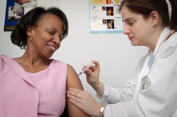 doctor giving lady an injection in her arm
