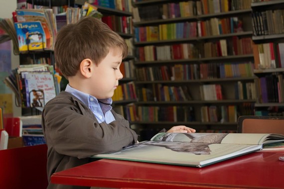 child sat reading in library