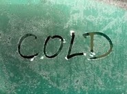 The word cold written on a pain of glass