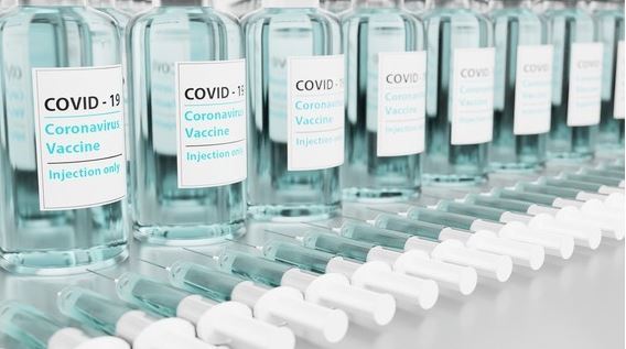 A row of vials with COVID-19 vaccine.