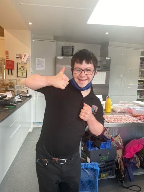 Joseph in the kitchen showing thumps up.