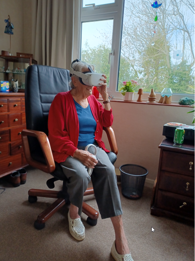 Lady sitting holding a virtual image headset
