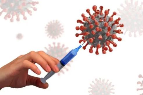 A hand holding a syringe and an image of a virus