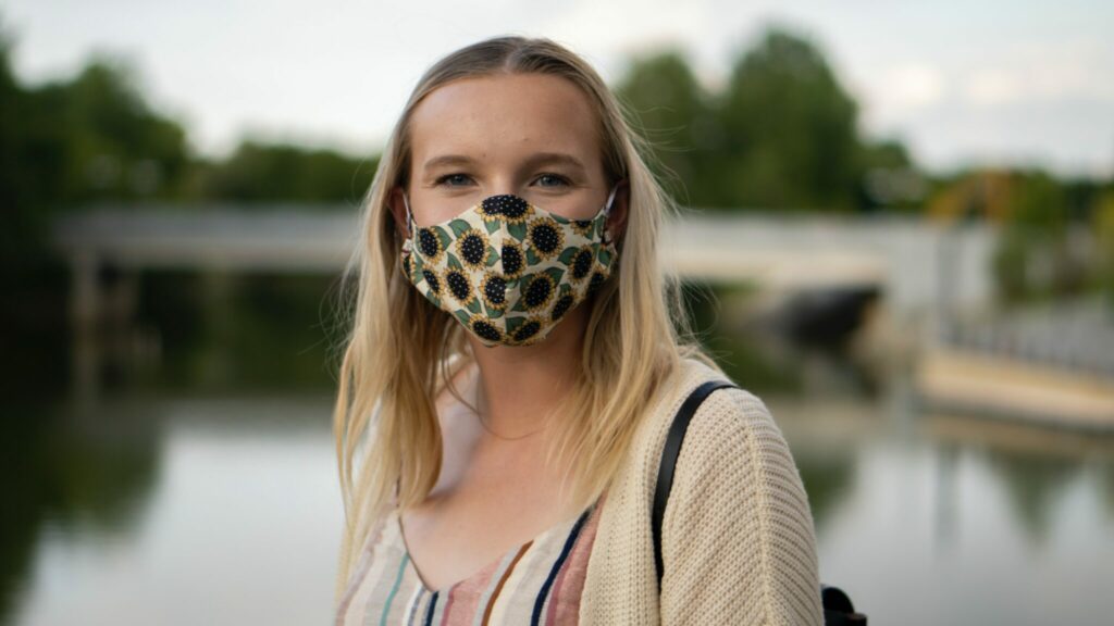 Young person wearing face covering outdoors
