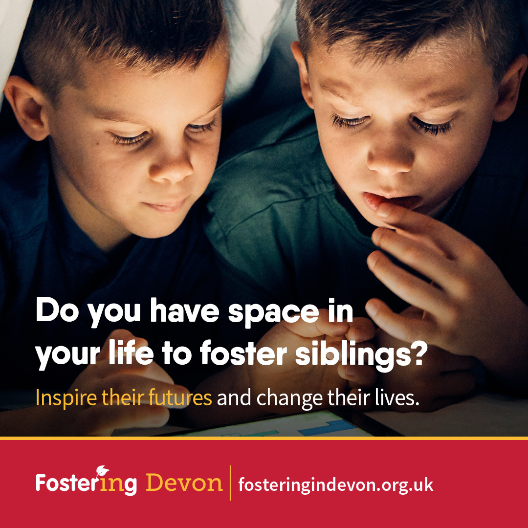 Foster carers for siblings advert - two brothers sat closely alongside each other focusing on something in front of them
