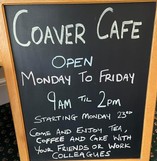 Coaver Cafe's board, advertising when they are open, and that they sell tea, coffee and cakes