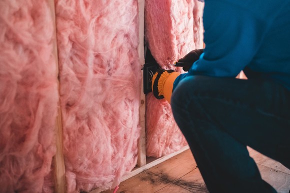 A tradesperson fitting cavity wall insulation