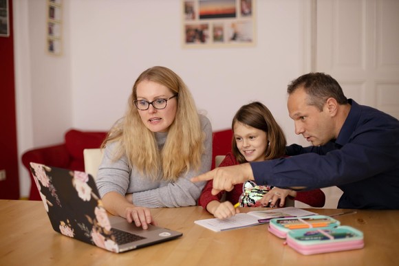 family around a laptop