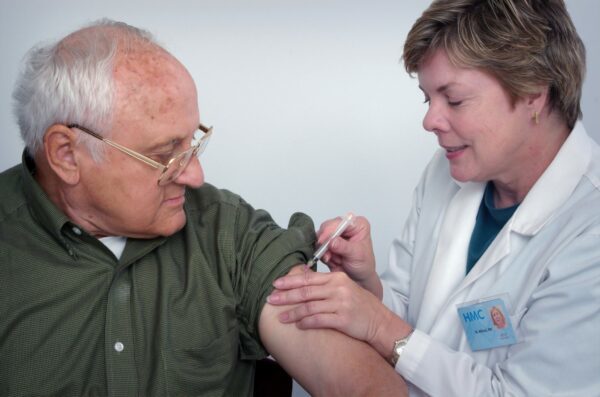 Elderly man receiving his vaccination