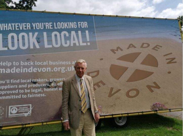 Councillor Rufus Gilbert stood by large Made In Devon sign and Look Local on side of van